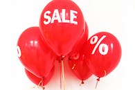 Bright red balloons with 'SALE' and '%' symbols, perfect for marketing promotions.